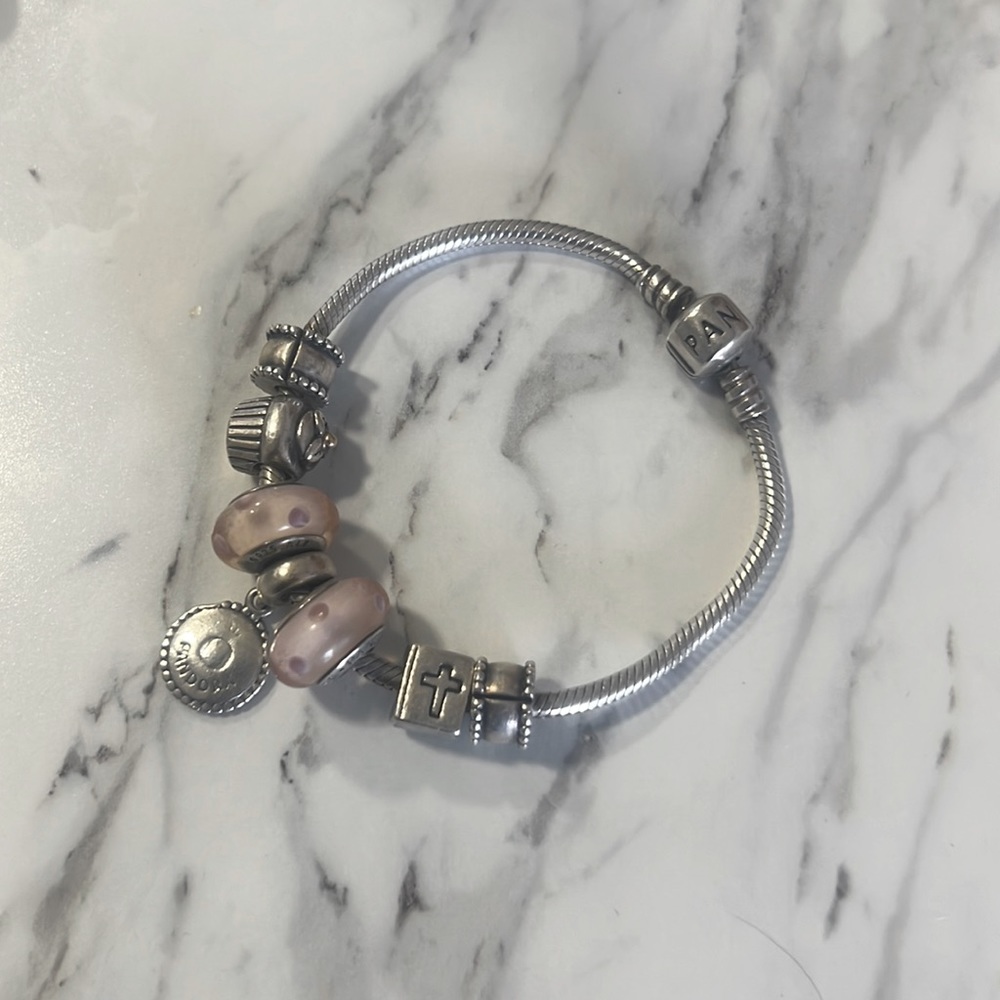 cupcake, bible, two decorated clasps, the signature pandora, and two pink dotted